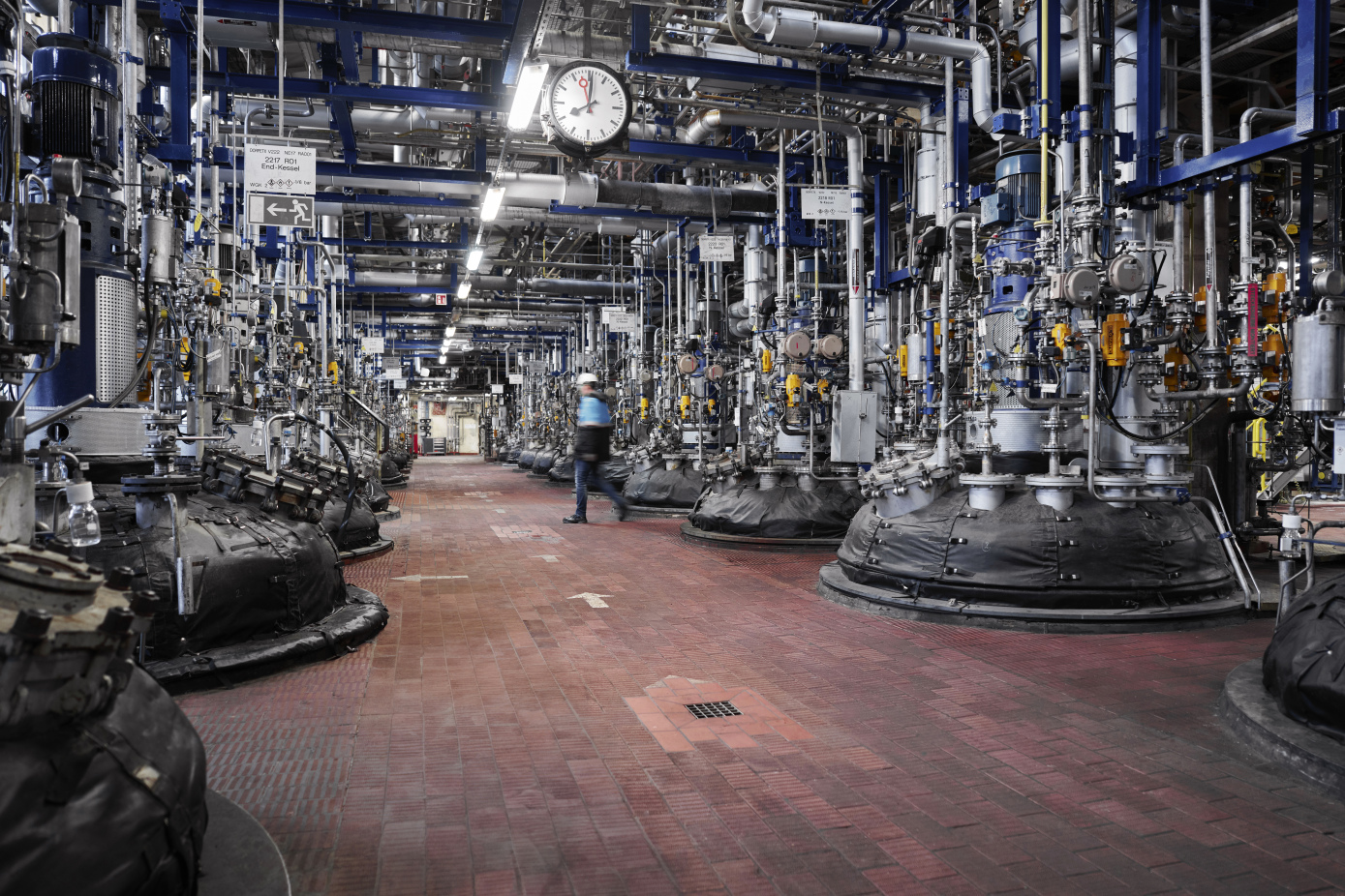 Employee walking through a plant at production site in Dormagen